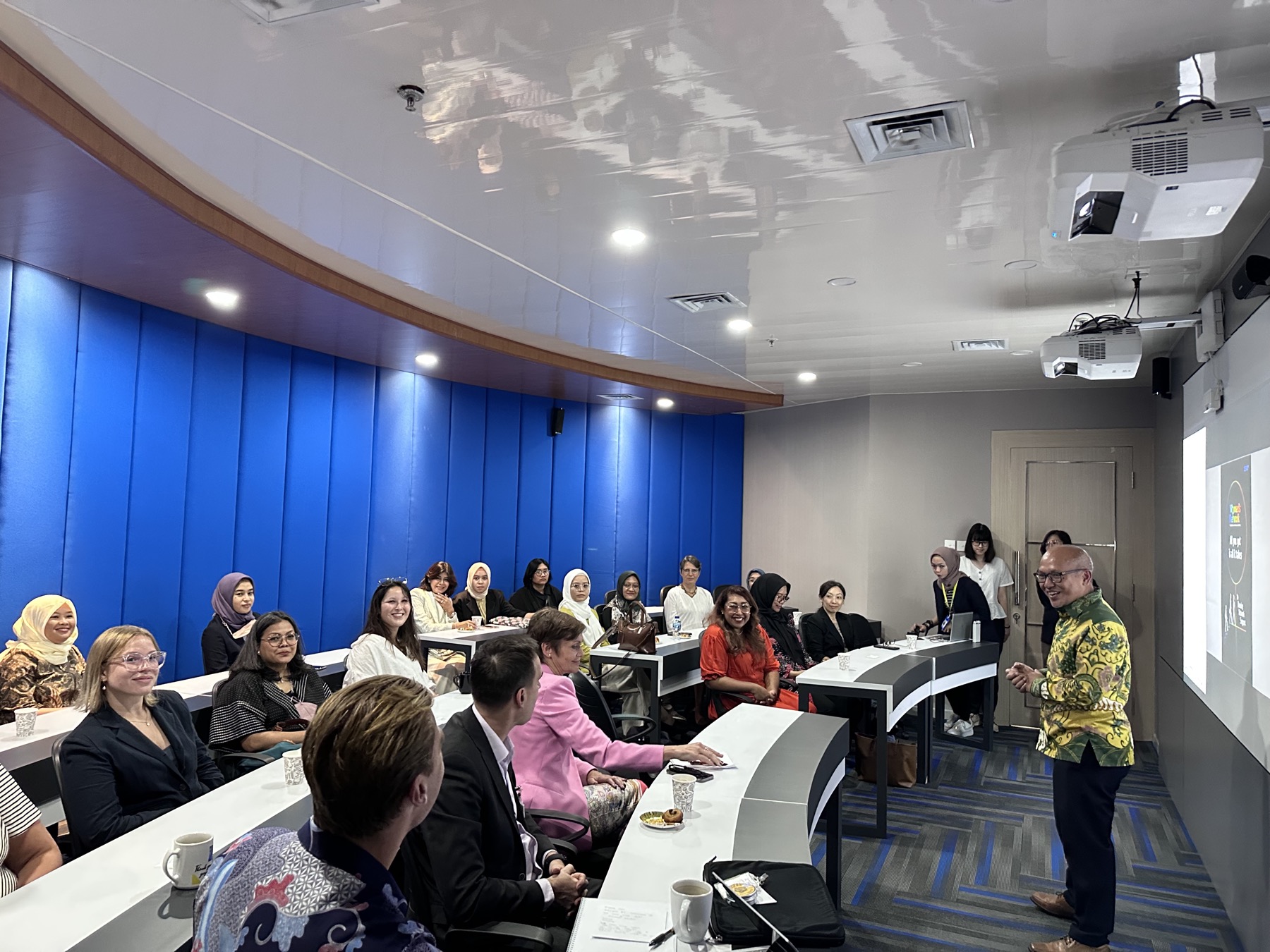 A seminar room of mostly women listening to a speaker